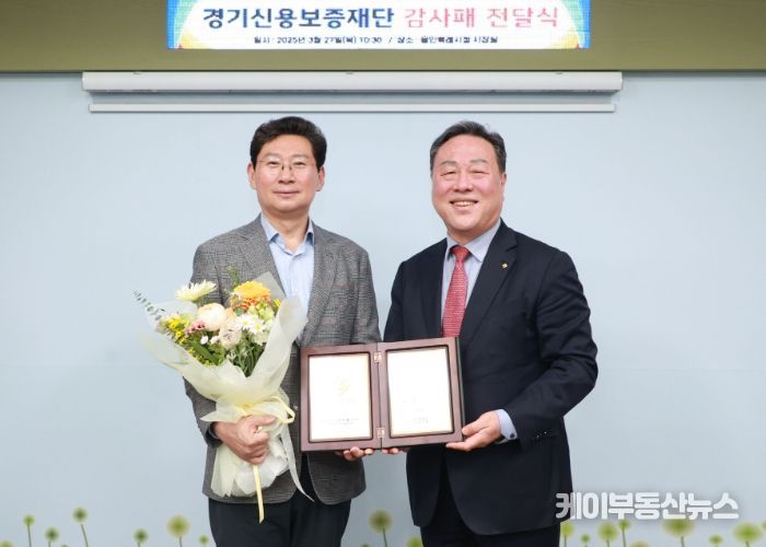 27일 용인특례시청 시장실에서 감사패 전달식 후 이상일 시장(왼쪽)과 시석중 경기신보 이사장이 기념사진을 찍고 있다.